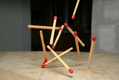 matches are arranged in the shape of an x on top of a marble countertop