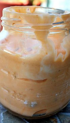 a jar filled with liquid sitting on top of a table