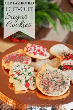 some sugar cookies with sprinkles are on a plate