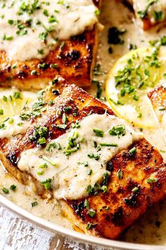 grilled salmon with lemon and chives on a white plate