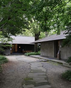 a stone path leading to a house in the woods