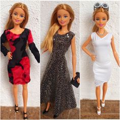 three barbie dolls in dresses and sunglasses standing next to each other