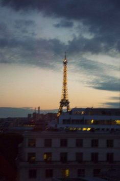 the eiffel tower lit up at night in paris, france as seen from an apartment building