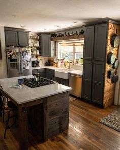 a kitchen with wooden floors and gray cabinets