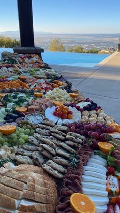 a long table filled with lots of different types of food on top of each other