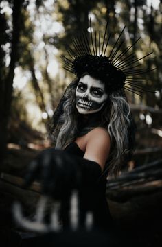 a woman in skeleton makeup and black gloves