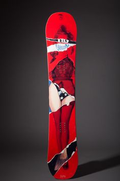 a red snowboard with an image of a woman in stockings and stockings on it