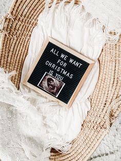 a sign that says all we want for christmas is you on top of a wicker basket