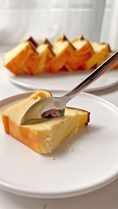 a piece of cake on a white plate with a knife and fork in the middle