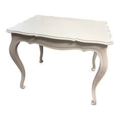 a small white table with an ornate design on it's top and bottom edge