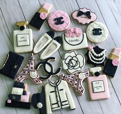 decorated cookies arranged in the shape of eiffel tower, chanel bottle and purses