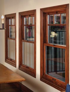 two windows with wooden frames in a room