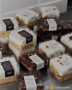 there are many different desserts on display in the glass containers with tags attached to them