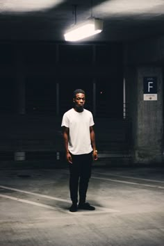 a man standing in an empty parking garage