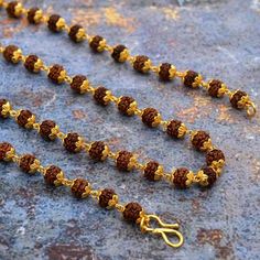 Beads is made using hand-picked, highest quality, smooth, hard, round and lustrous 5 mukhi Rudraksha beads from Java (Indonesia) along with a beautiful orange tassel. The mala can be worn or can be used for Mantra Japa. Benefits and Purpose: 5 mukhi Rudraksha beads enhances self-work and induce confidence 5 mukhi Rudraksha bead blesses the wearer with health, prosperity, and success The Mala increases concentration, memory and creativity The Mala helps aid meditation and Spiritual sadhana Size: Temple Necklace With Latkans And Round Beads For Festivals, Temple Necklace With Tilla And Round Beads For Festivals, Festival Temple Necklace With Tilla And Round Beads, Festival Gold Beads Temple Necklace, Gold Mala With Tilla And Round Beads, Gold Mala With Round Beads For Festivals, Gold Temple Necklace With Gemstone Beads For Festivals, Festival Brown Necklace For Puja, Brown Necklaces For Puja And Festivals