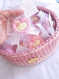 a pink basket filled with lots of little hearts