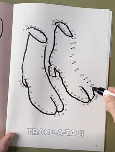 a hand is drawing a race track on a piece of paper that has the numbers in it