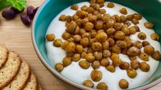 grapes and yogurt in a bowl next to crackers