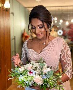 a woman holding a bouquet of flowers in her hands