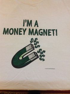 i'm a money magnet t - shirt in white with green writing on the front