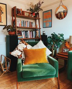 a living room filled with furniture and bookshelves next to a wall mounted book shelf