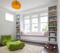 a child's bedroom with green bean bag chair and bookshelves