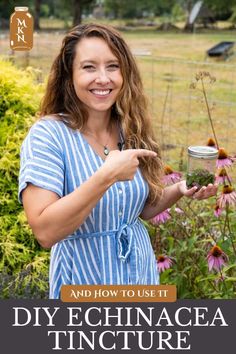 a woman pointing at flowers with the words diy echincea tincture on it