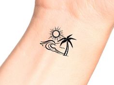 a small palm tree and wave tattoo on the left side of the wrist is shown