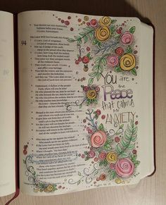 an open bible with flowers and words on the page, which reads you are peace