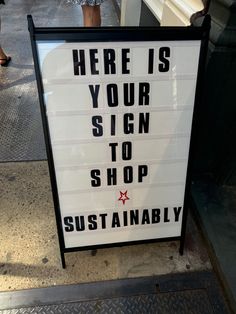 there is a sign on the sidewalk that says here is your sign to shop successfully