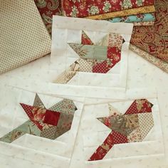 four quilted birds sitting next to each other