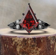 a red diamond ring with black diamonds on it