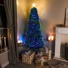 a blue christmas tree with presents under it