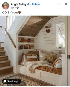 a couch sitting under a window next to a stair case in a room with white walls