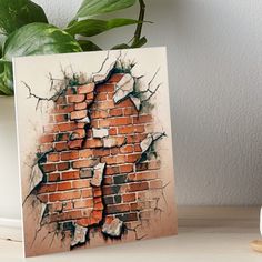 a brick wall that has been torn down and is being displayed on a table next to a potted plant