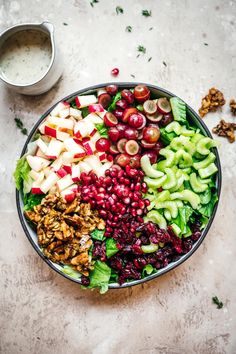 a bowl filled with fruit and nuts on top of a table