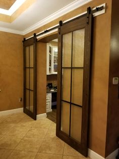 an empty room with sliding glass doors in the middle and tile flooring on the other side