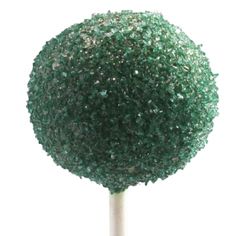 a close up of a small green ball on a stick with glittery topper