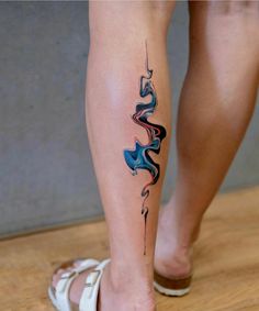 a woman's leg with an abstract tattoo design on the left side of her body