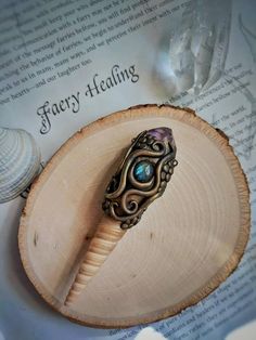 a ring sitting on top of a piece of wood