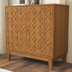 a wooden cabinet sitting on top of a hard wood floor next to a white rug