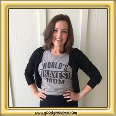 a woman wearing a world's okayest mom shirt with her hands on her hips