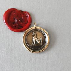 a wax seal with a dog on it and a red wax seal in the background