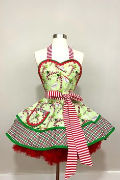 a mannequin dressed up as a christmas dress with red and green stripes on it