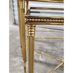 a gold metal and glass side table