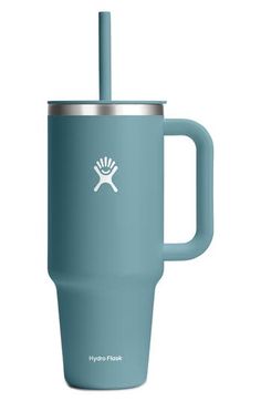 the hydro flask tumbler in blue is shown with a stainless steel lid and handle