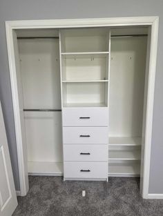 a white closet with drawers and shelves in the middle of carpeted flooring area