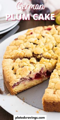 a close up of a pie on a plate with the words german plum cake above it