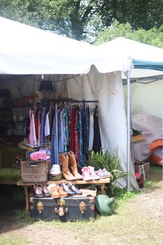 an open tent with clothes and shoes on display