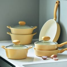 yellow pots and pans are sitting on the counter